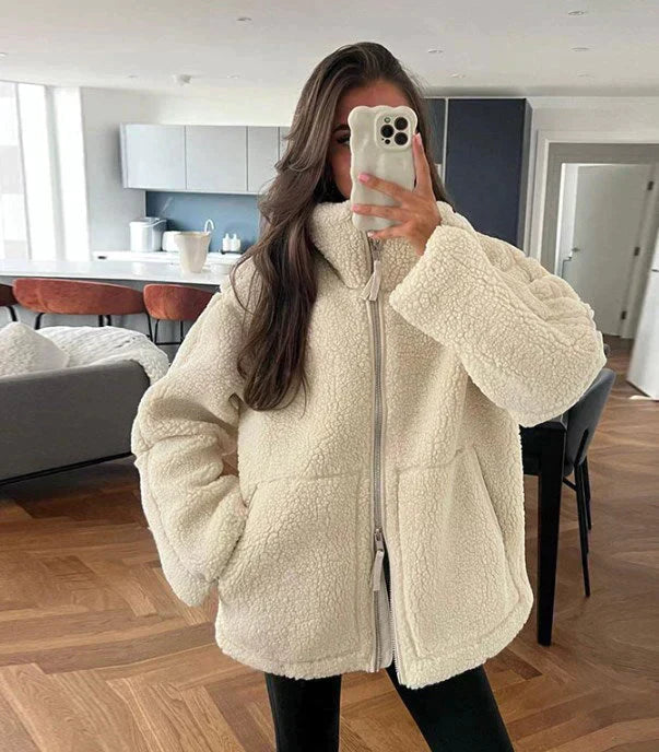 Soft women's teddy fleece jacket with front zipper. Casual, warm outerwear with a stand-up collar.