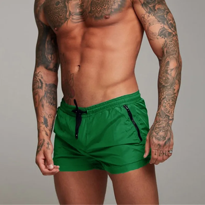 Trendy quick-dry men's swim shorts with zippered pockets, ideal for active beachgoers.