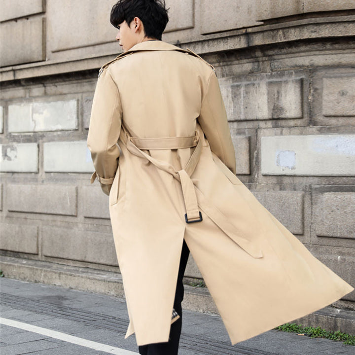 Long men's trench coat, double-breasted design with a stylish belt. Classic men's outerwear for sophisticated style.