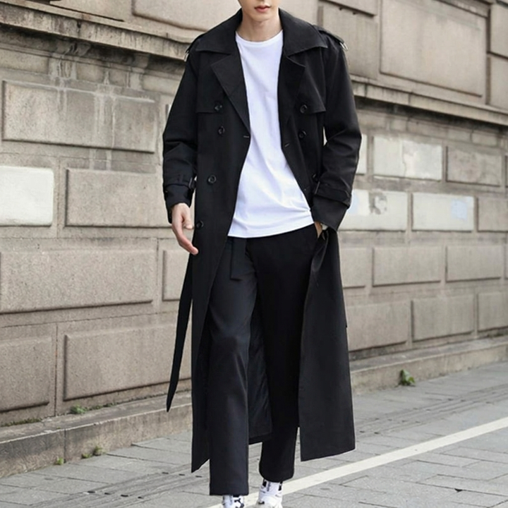 Men's fashion double-breasted trench coat with a belt. Long, classic style outerwear, ideal for autumn and winter.