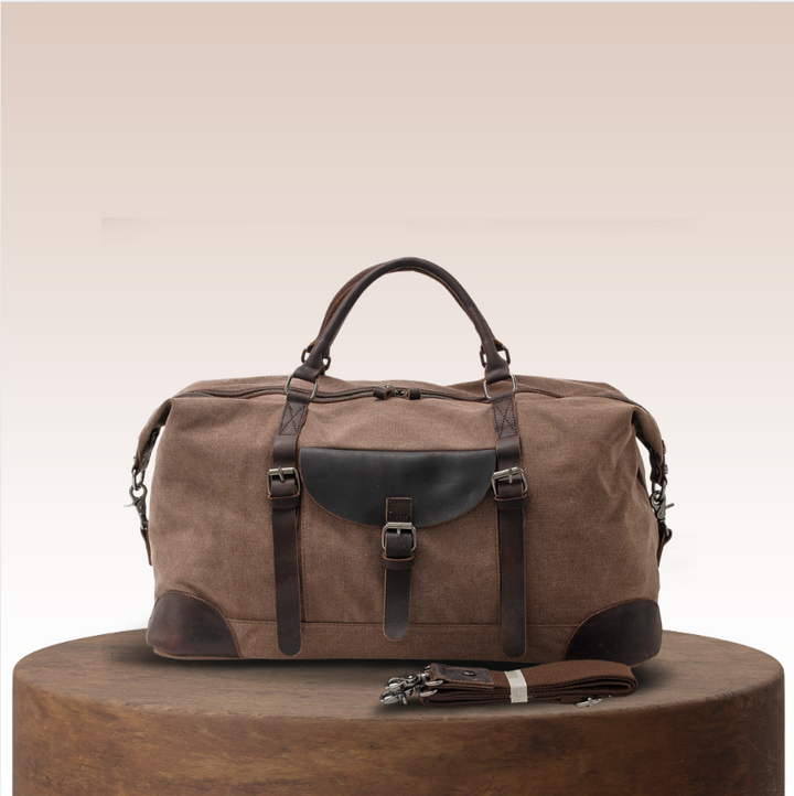 Stylish men's canvas duffle bag, perfect for travel & weekend getaways. Features durable straps for shoulder carry.