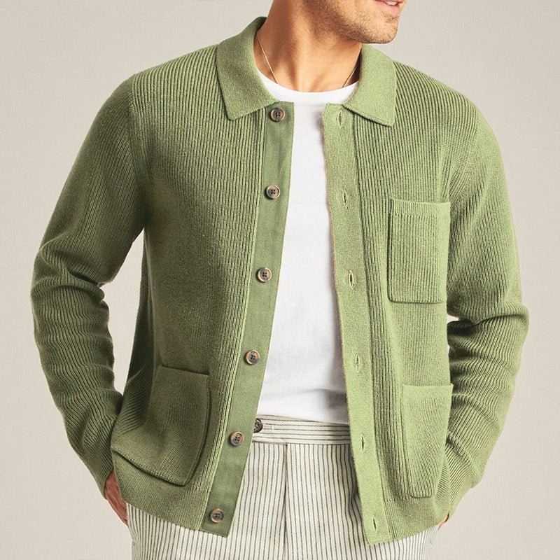 Close-up of men's green knit cardigan showing button-up front, ribbed cuffs, and textured patch pockets.