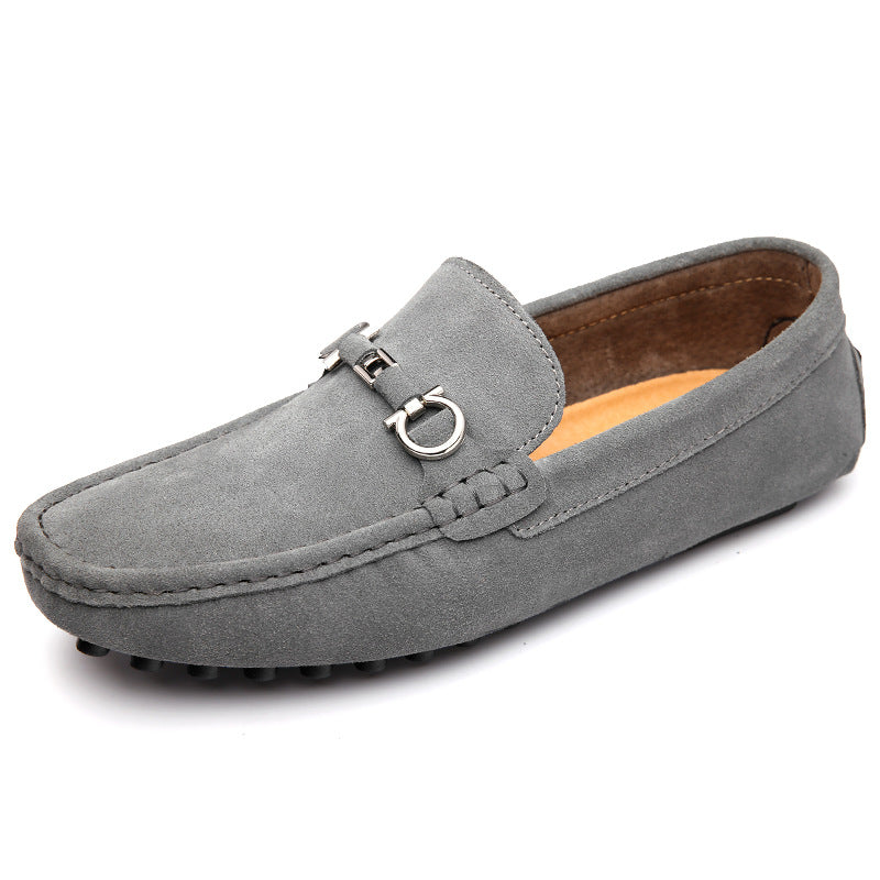 Men's black slip-on moccasin driving loafers on foot, showing stylish and comfortable everyday wear.