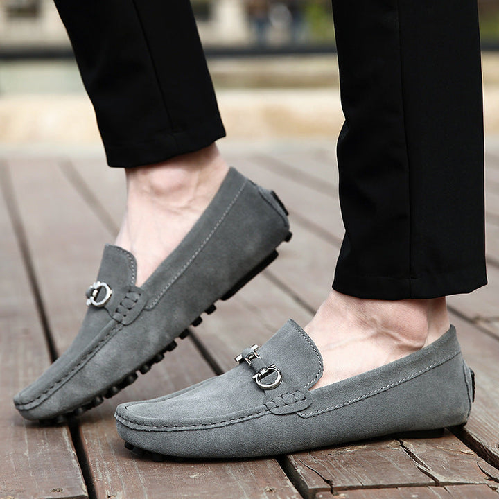 Close-up of black men's slip-on moccasin loafers, showcasing texture and comfortable everyday style.