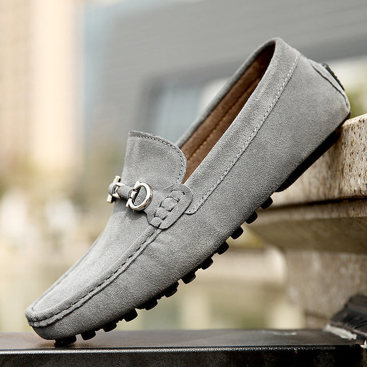 Side view of grey men's driving loafers. Comfortable slip-on moccasins, ideal for smart casual fashion.