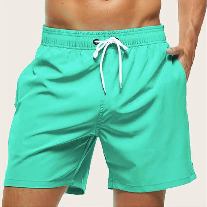 Stylish men's quick-dry beachwear swim shorts with elastic waist, great for resort, pool, and summer vacation.
