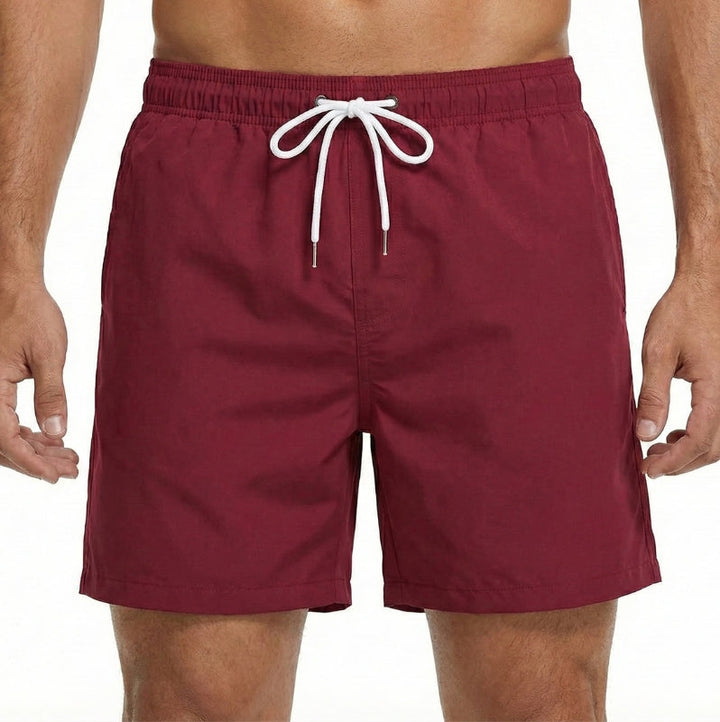 Men's quick-dry board shorts, elastic waist for comfort. Essential beachwear for summer, pool, and resort trips.