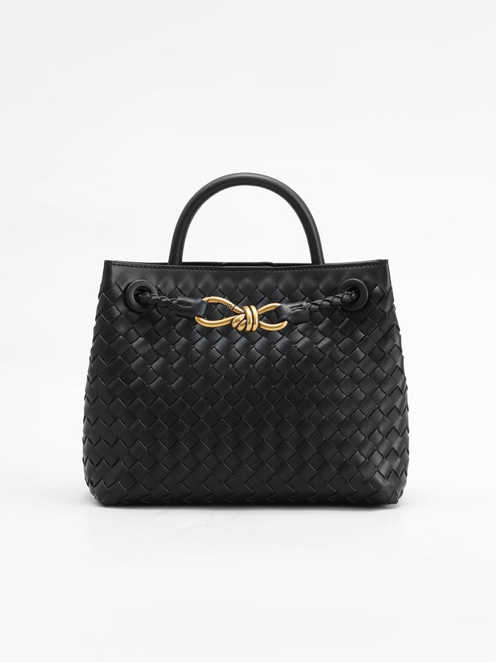 Elegant black woven top handle bag for women, featuring a structured design and a chic twist accent.