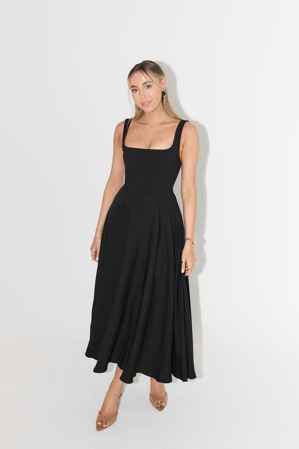 Elegant women's midi dress with square neck, embodying chic fashion for sophisticated occasion wear.