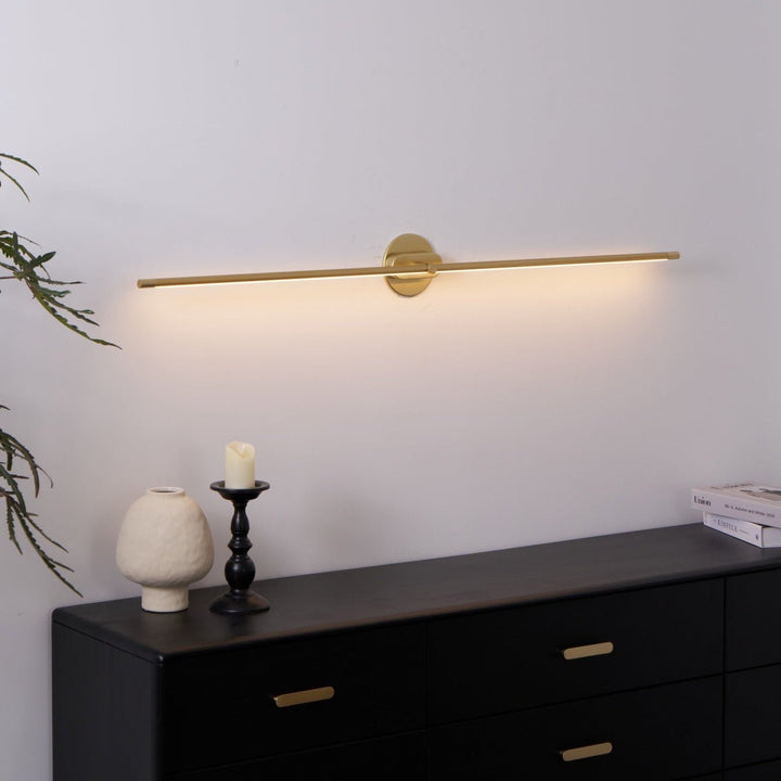 Gold finish linear LED wall sconce, minimalist, hallway.