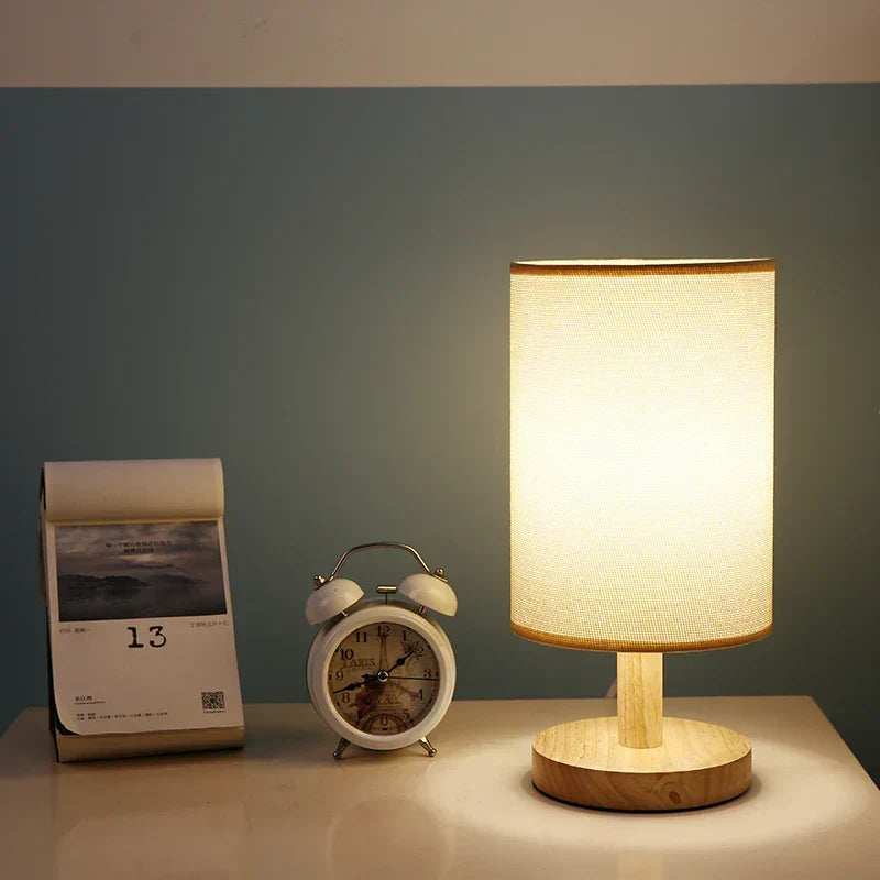 Natural wood table lamp with soft fabric shade. Dimmable LED, adjustable brightness for cozy spaces.