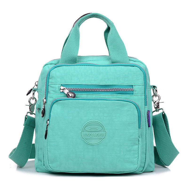 Modern water-resistant women's travel bag, functions as a stylish crossbody or shoulder bag. New release.