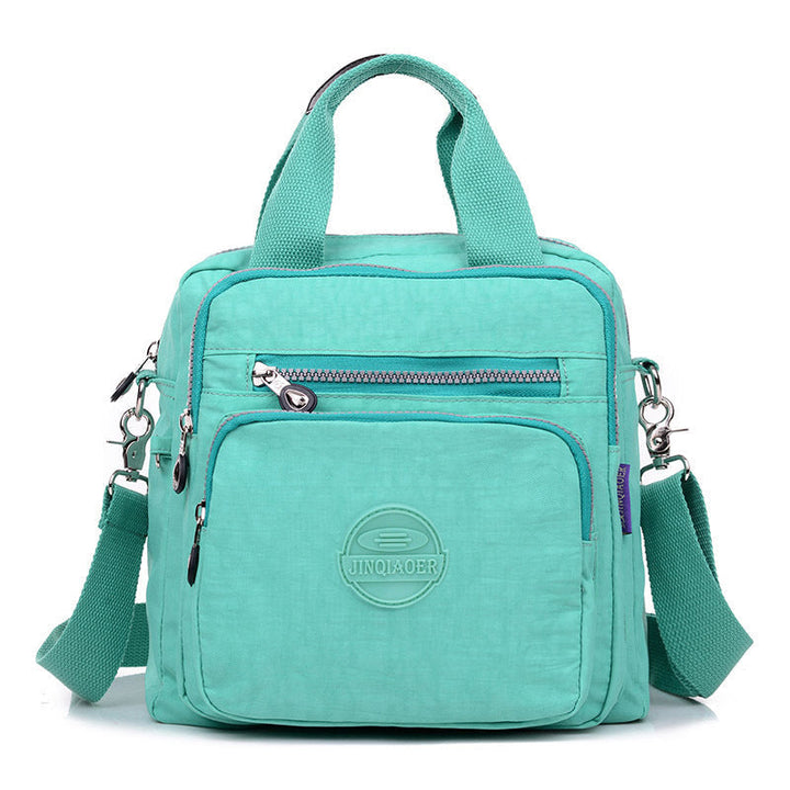 Modern water-resistant women's travel bag, functions as a stylish crossbody or shoulder bag. New release.