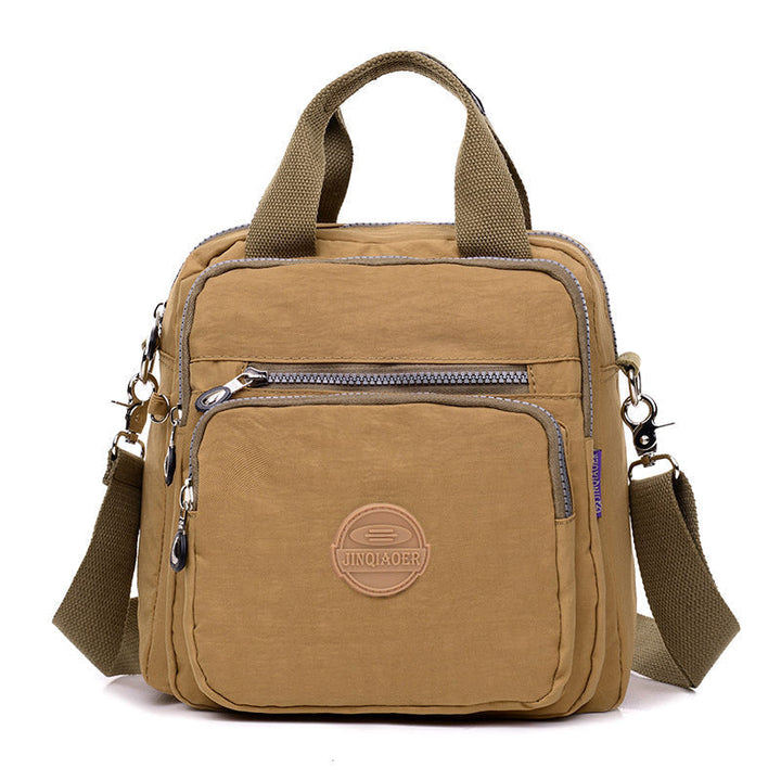 Back view of new water-resistant women's shoulder bag, showing comfortable and adjustable strap.