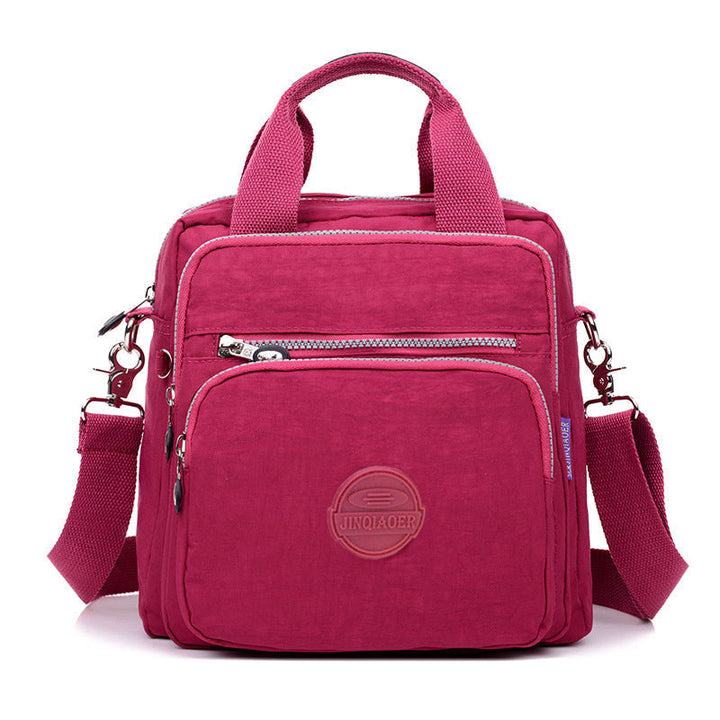 Side profile of a new water-resistant women's shoulder bag, highlighting its slim yet spacious design.