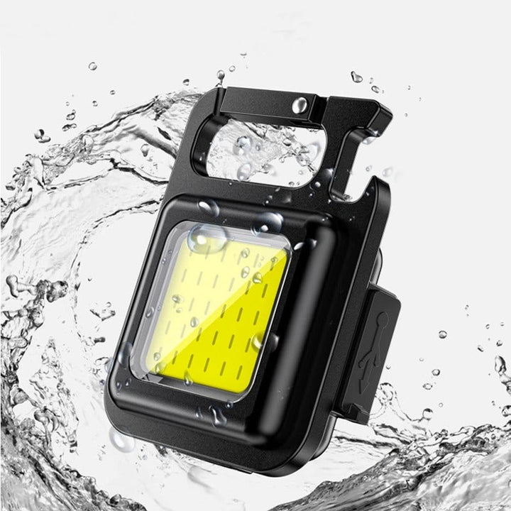 Portable utility flashlight: mini COB LED, rechargeable battery, and convenient bottle opener. EDC ready.
