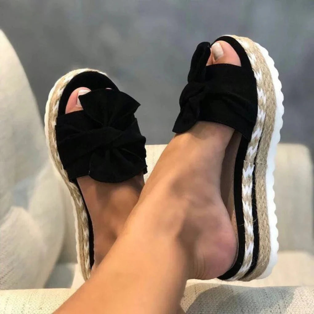 Comfortable women's summer vacation sandals, easy slip-on style with a charming bow detail.
