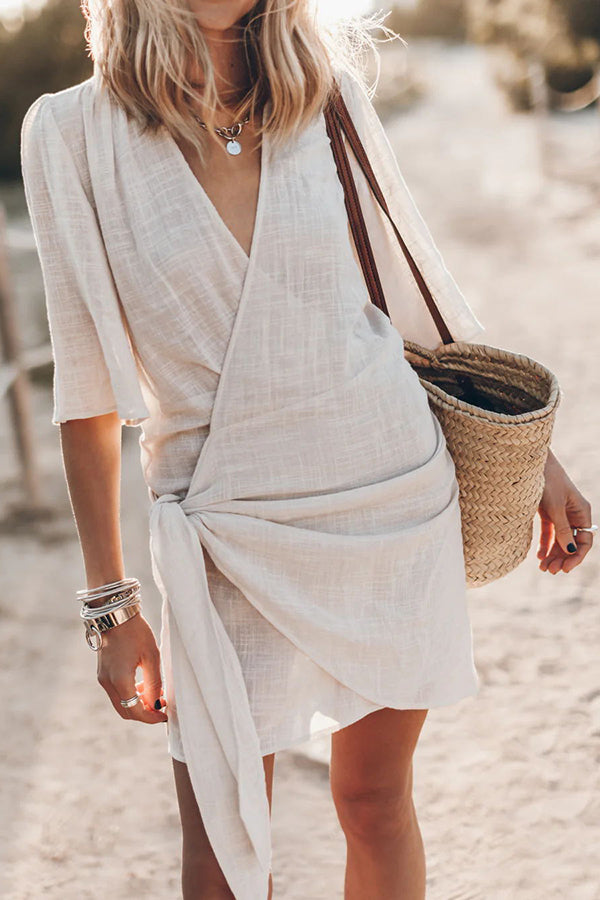 Elegant women's wrap mini dress with asymmetrical hem, ideal for cocktail parties, summer events, & evening wear.