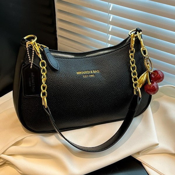 White elegant structured shoulder bag for women, sophisticated faux leather design.