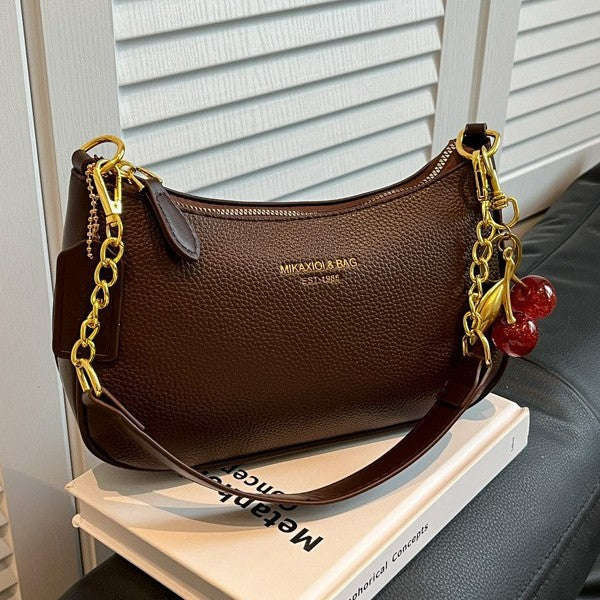 Fashionable black structured faux leather handbag, versatile women's crossbody bag.