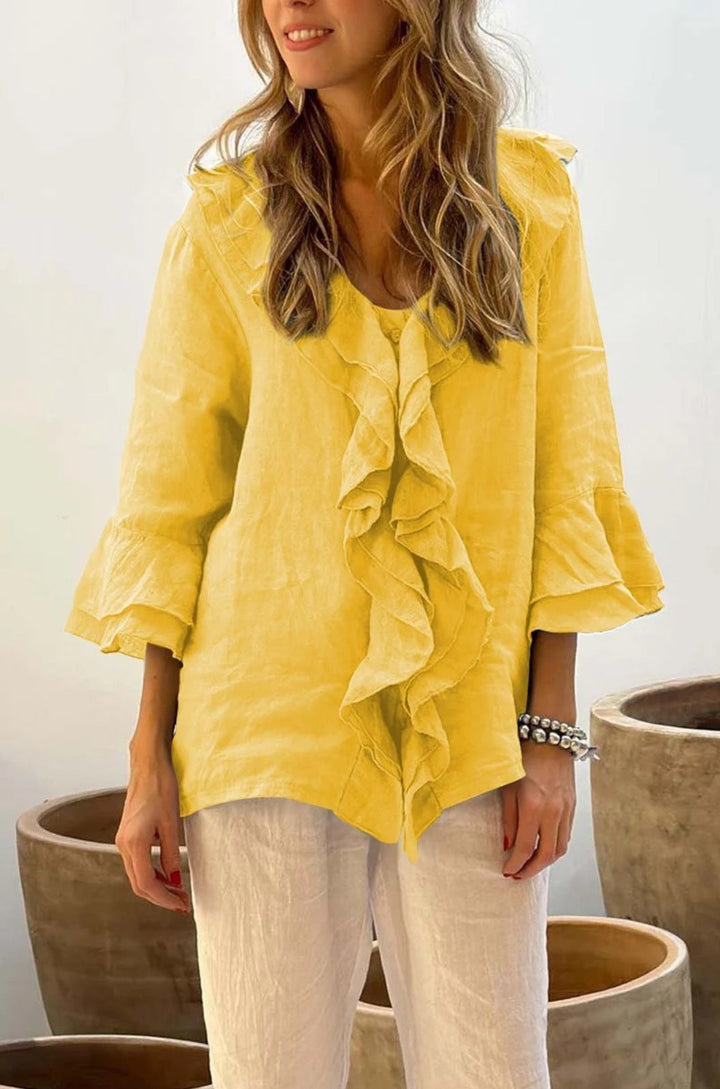 Fashionable women's ruffled 3/4 sleeve blouse, combining elegant style with a relaxed, versatile fit.