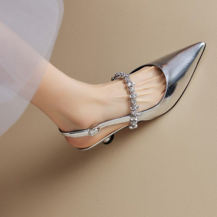 Women's elegant silver crystal slingback pointed pumps with a low heel, perfect for parties.