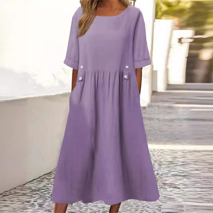 Elegant women's breezy summer midi dress with round neck, short sleeve, ideal for casual everyday wear.