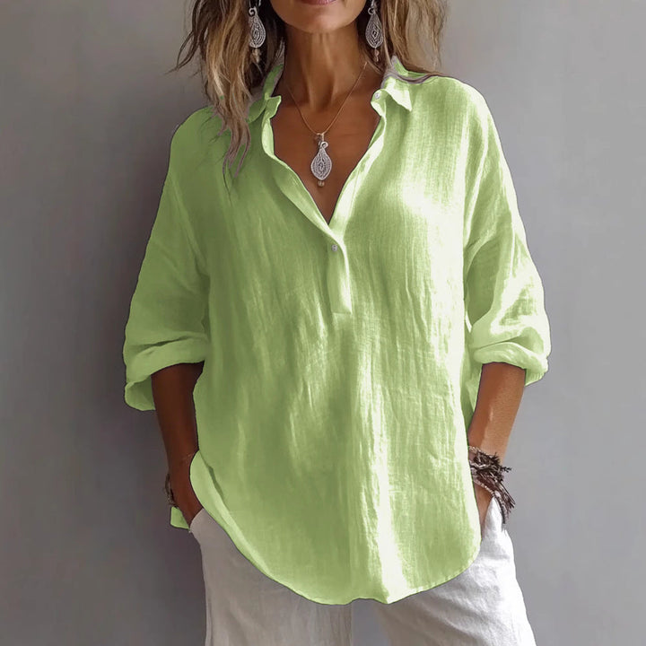 Lightweight women's button-up blouse with wide sleeves, great for versatile summer fashion.