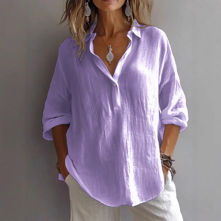 Stylish women's button-up blouse with flowing wide sleeves, ideal for a relaxed look.