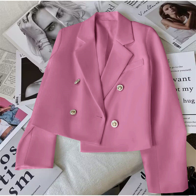 Pink cropped women's blazer with double-breasted tailoring and lapels. Stylish jacket for versatile fashion.