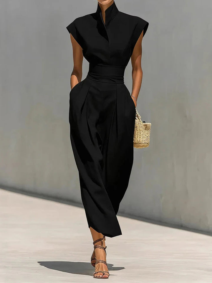 Elegant women's sleeveless mock-neck midi dress, tailored fit with hidden pockets, suitable for work or events.