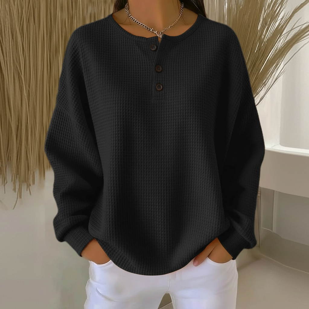 Stylish women's waffle knit top with functional button-front closure and a modern drop shoulder silhouette.