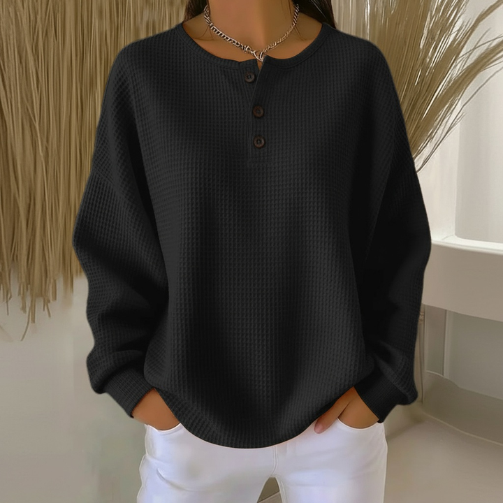 Stylish women's waffle knit top with functional button-front closure and a modern drop shoulder silhouette.