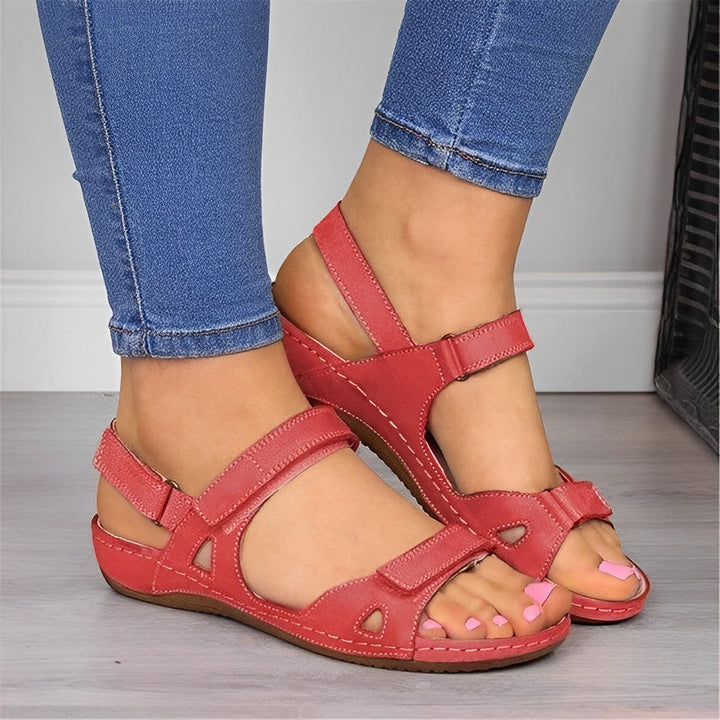 Woman wearing orthopedic arch support sandals, enjoying comfortable walking on a sunny summer day.