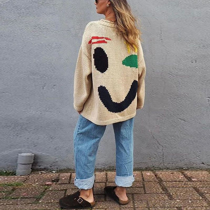 Trendy women's oversized smiley face cardigan. Cozy long sleeve knitwear sweater for casual fall & winter layering.