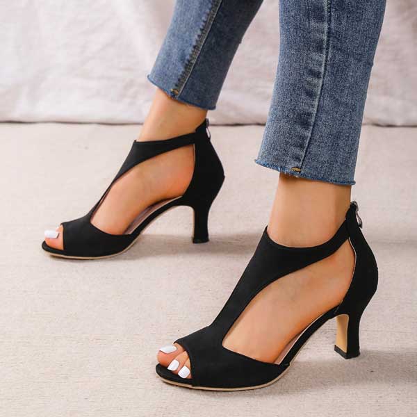 Woman walking in supportive orthopedic heeled sandals, offering comfortable and elegant all-day footwear.