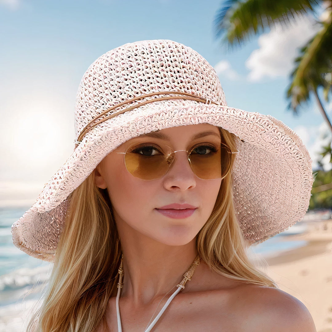 Elegant women's straw wide-brim sun hat, a fashionable vacation accessory for summer, offering UV protection.