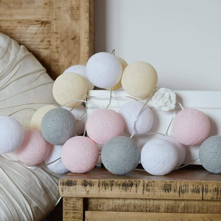 Cotton ball mood lights on a bookshelf, adding a warm glow and character to literature.