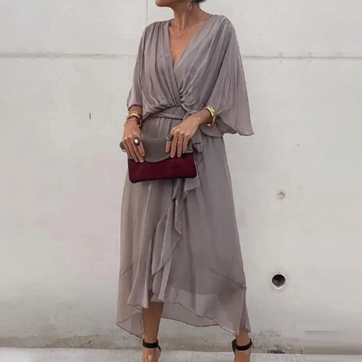 Stylish women's V-neck midi dress, versatile for elegant formal wear or sophisticated casual chic. Modern fashion.