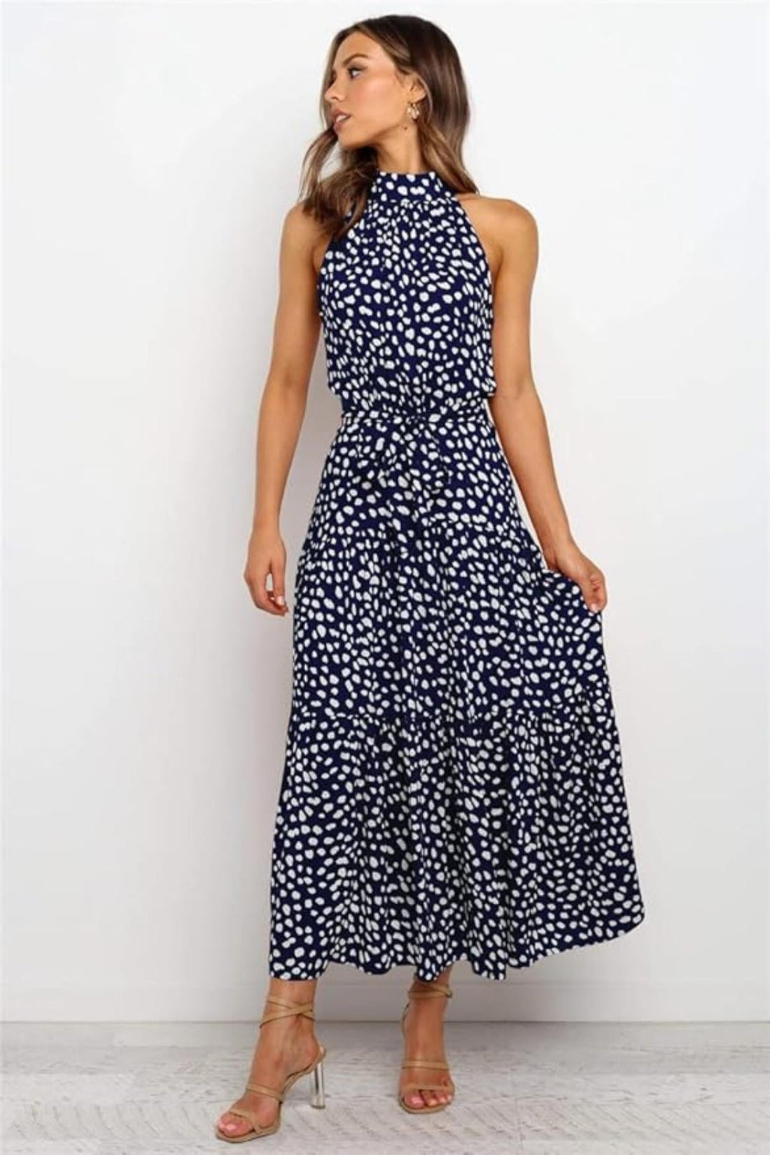Stylish polka dot halter midi dress for women, with a chic flared design, ideal for summer.