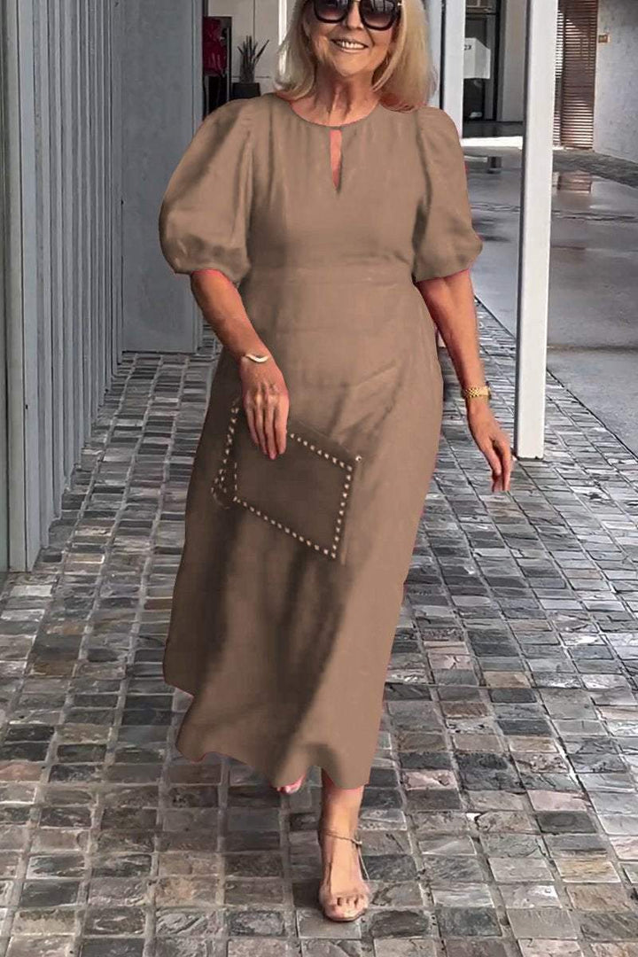 Women's elegant A-line midi dress with puff sleeves & practical pockets. Ideal for office wear.