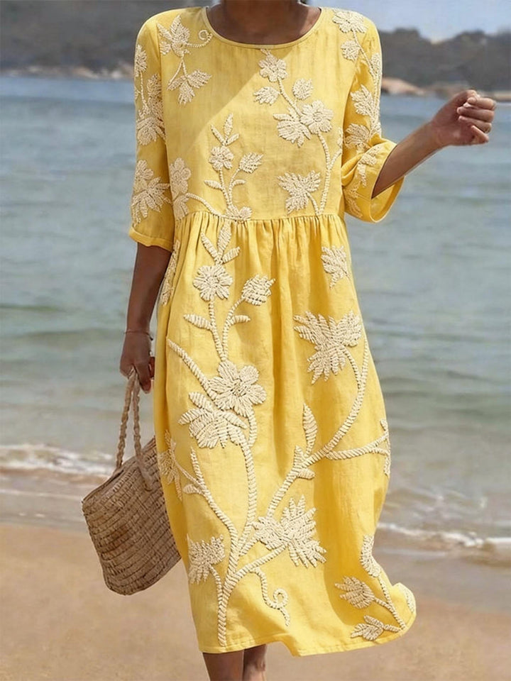 Charming women's floral midi dress with a simple round neck, perfect for garden parties or summer outings.