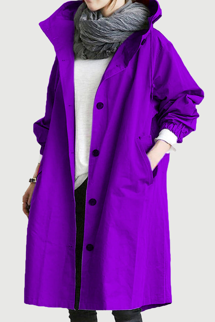 Close-up of women's water-resistant hooded windbreaker. Oversized, packable for everyday outerwear.