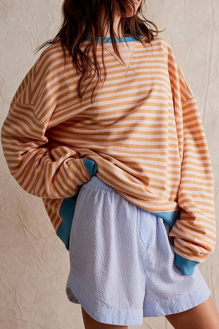 Stylish striped women's oversized sweater, a cozy top for effortless, relaxed layering.
