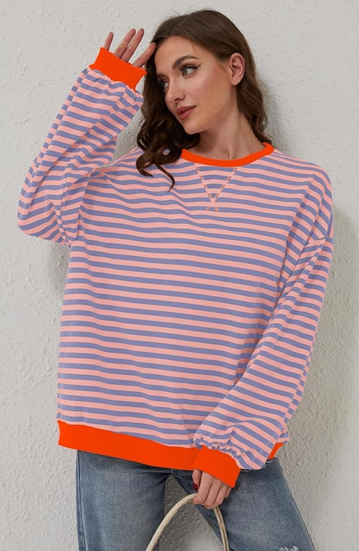 Cozy women's oversized sweater with classic stripes, offering a relaxed fit for versatile styling.