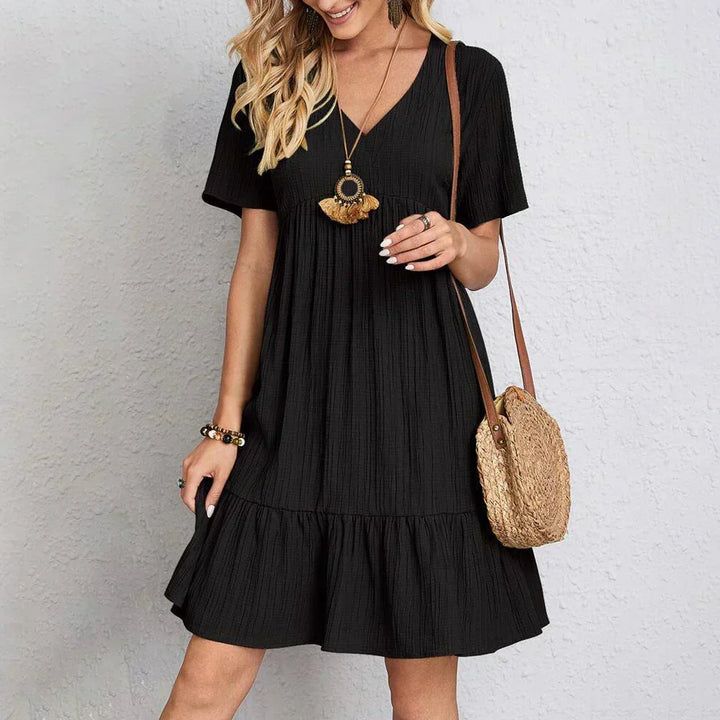 Stylish women's Adeline V-neck summer dress. Flowy short sleeve midi for comfortable warm weather fashion.