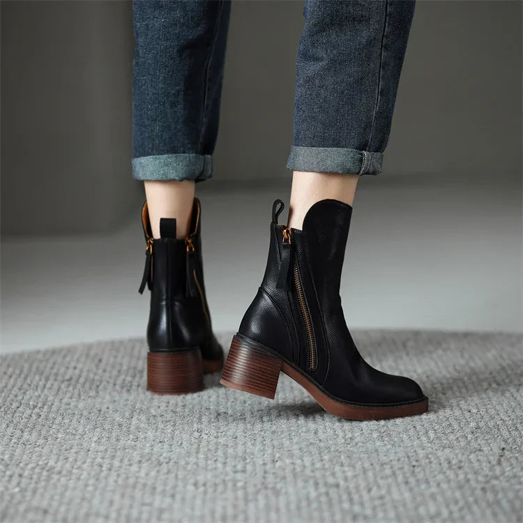 Chic women's Emery ankle boots for fall/winter elegance. Comfortable zip closure & stylish platform heel. Versatile.
