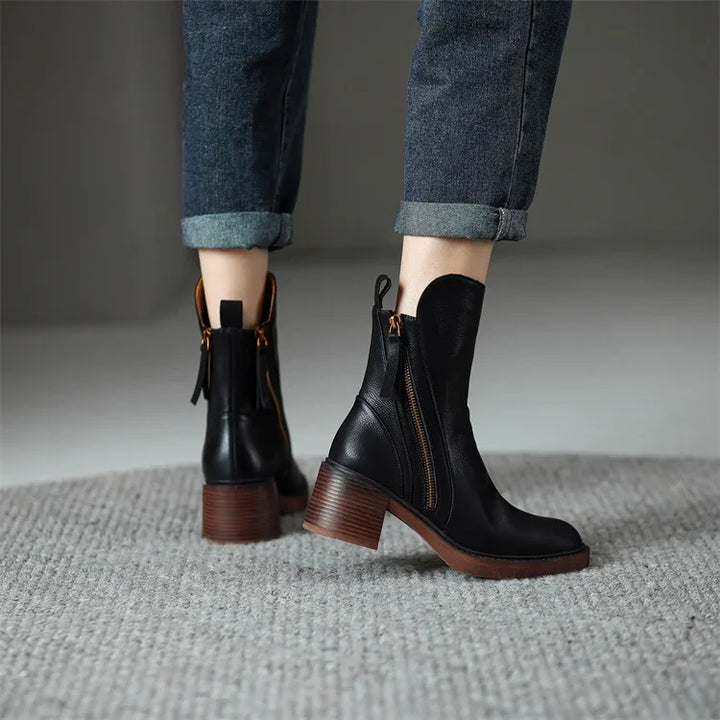 Chic women's Emery ankle boots for fall/winter elegance. Comfortable zip closure & stylish platform heel. Versatile.
