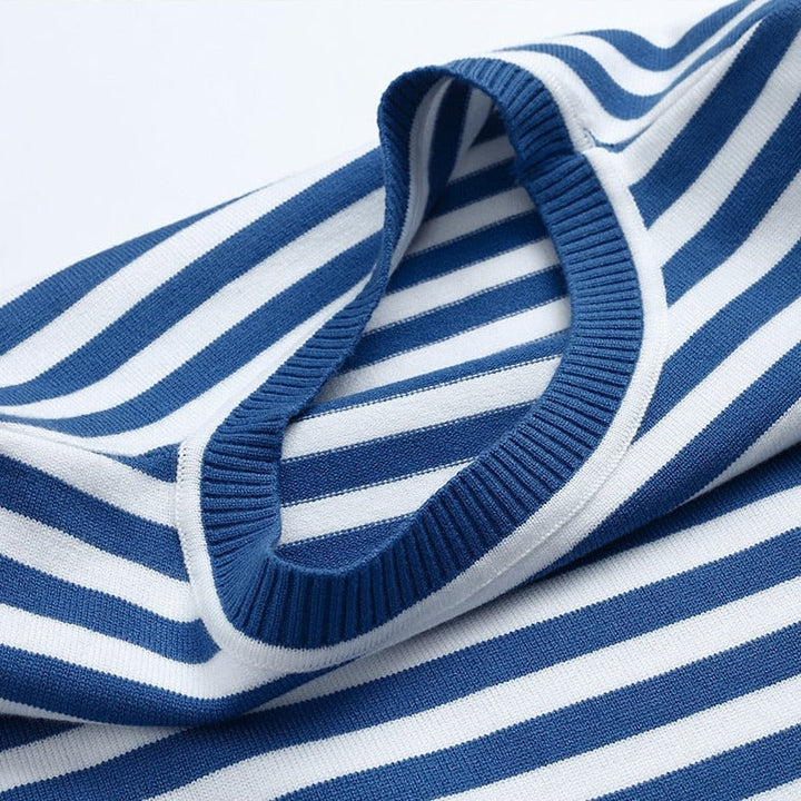 Folded women's striped knit sweater. Casual long sleeve crew neck pullover, ready for autumn/winter layering.