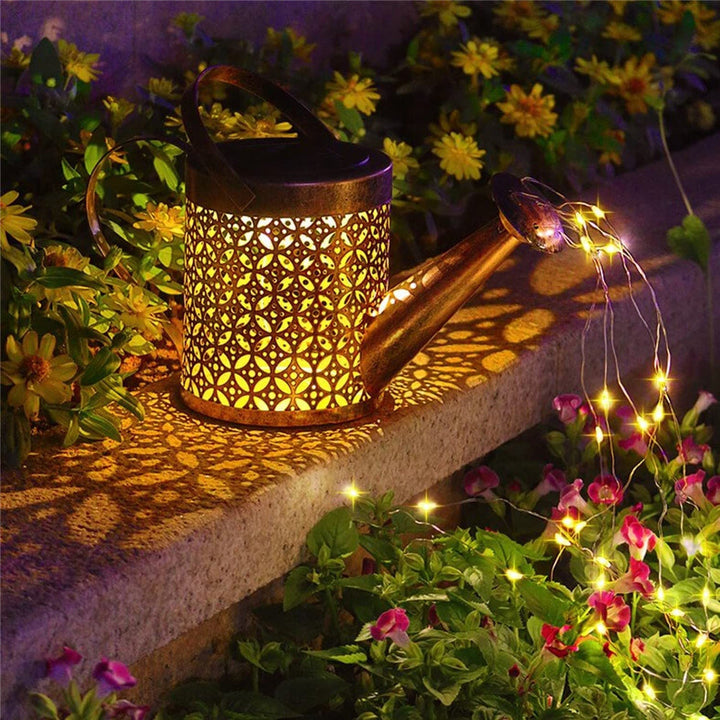 Solar LED watering can garden light, enchanting outdoor decor with pouring string lights for yard & patio.